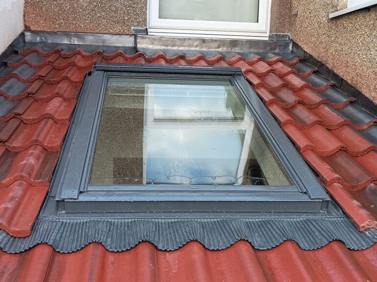 velux window on red tile roof